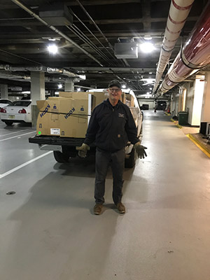 A facilities employee works in the garage